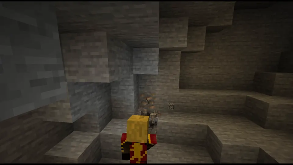 A miner working a cave by torchlight